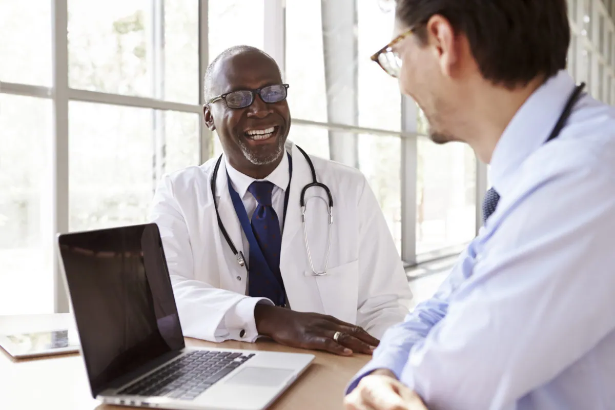 Doctor talking with a colleague in a bright medical office