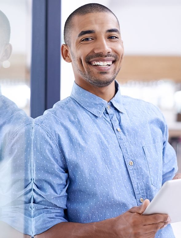 Man smiling with a tablet in his hands