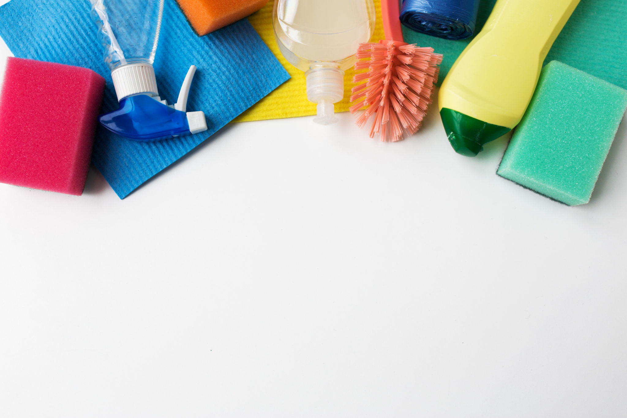 Three commercial cleaners cleaning around a desk