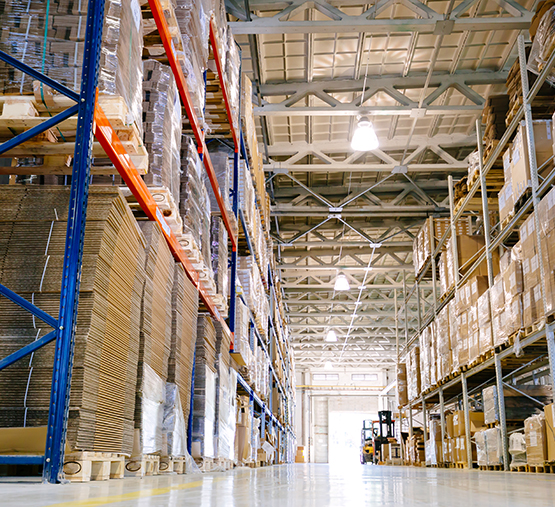 Four workers walking in a storage warehouse
