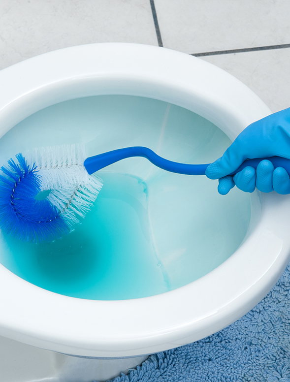 Woman performing commercial cleaning duties in an office